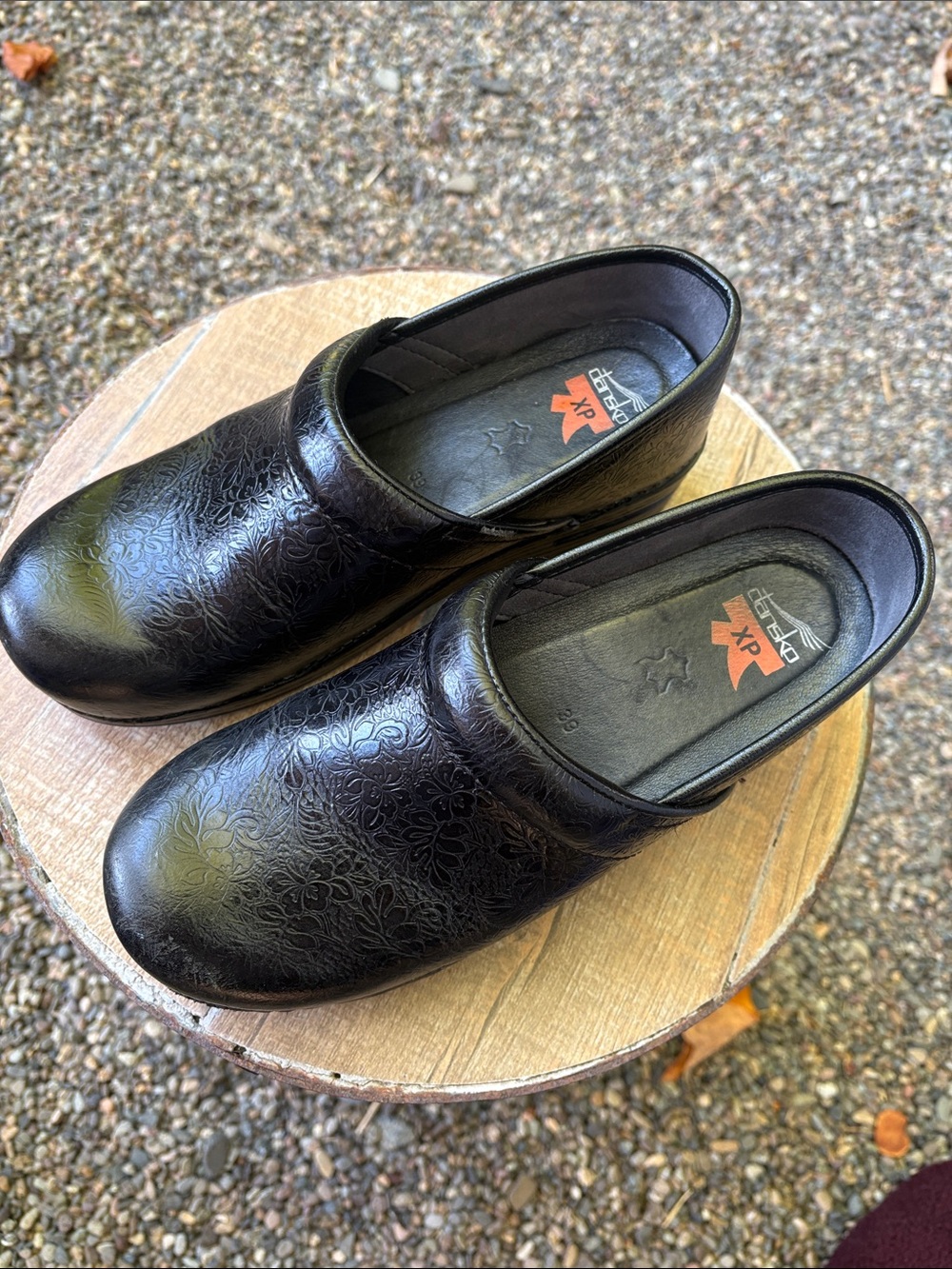 Dansko Black Leather Slip-On Clogs with Subtle Floral Embossing